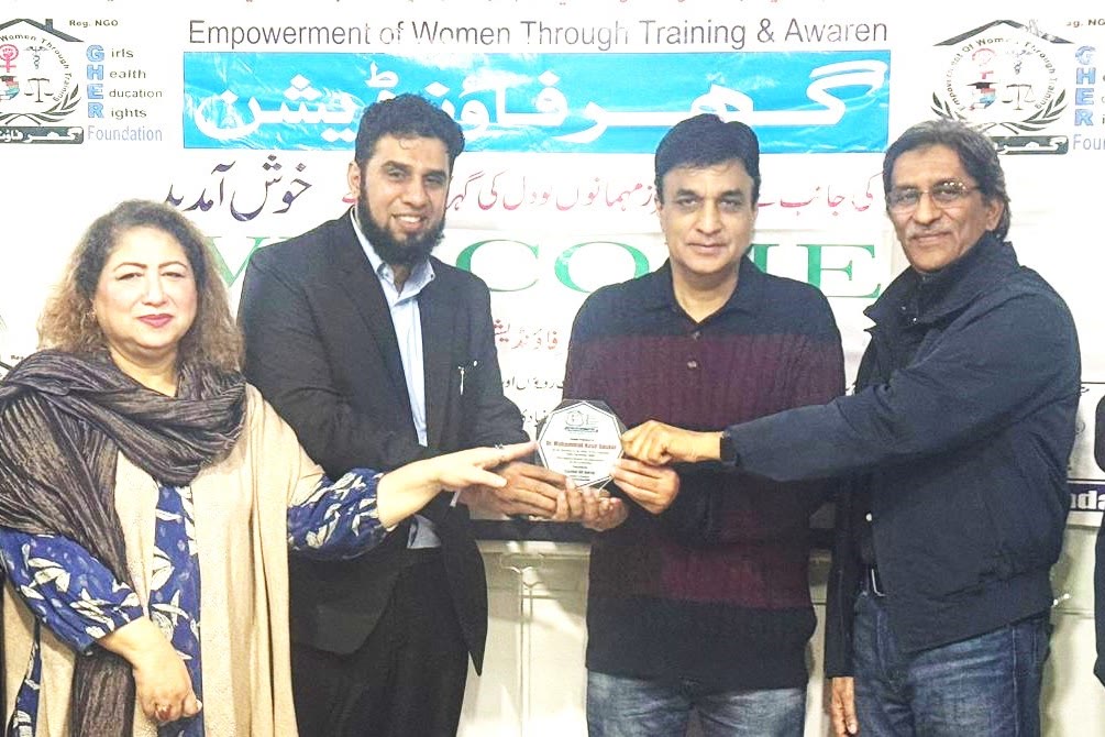 GHER Foundation team presenting a recognition shield to a guest
